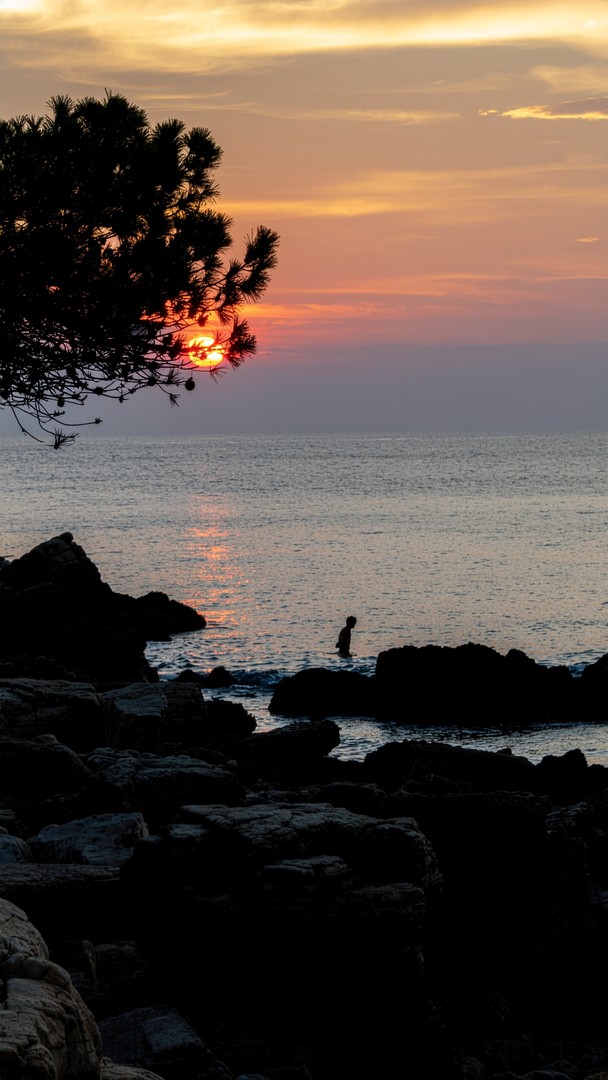 Sunset Rocky Shore Wallpaper - Lone Silhouette Ocean View 4K