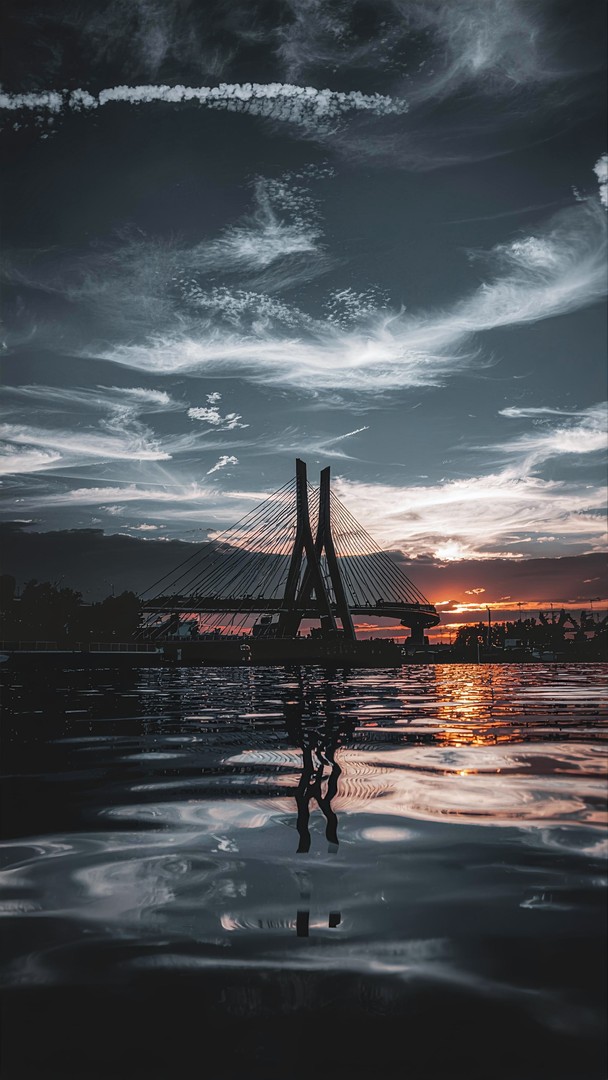 Dramatic Bridge Sunset Reflection Wallpaper – Urban Sky and Water View