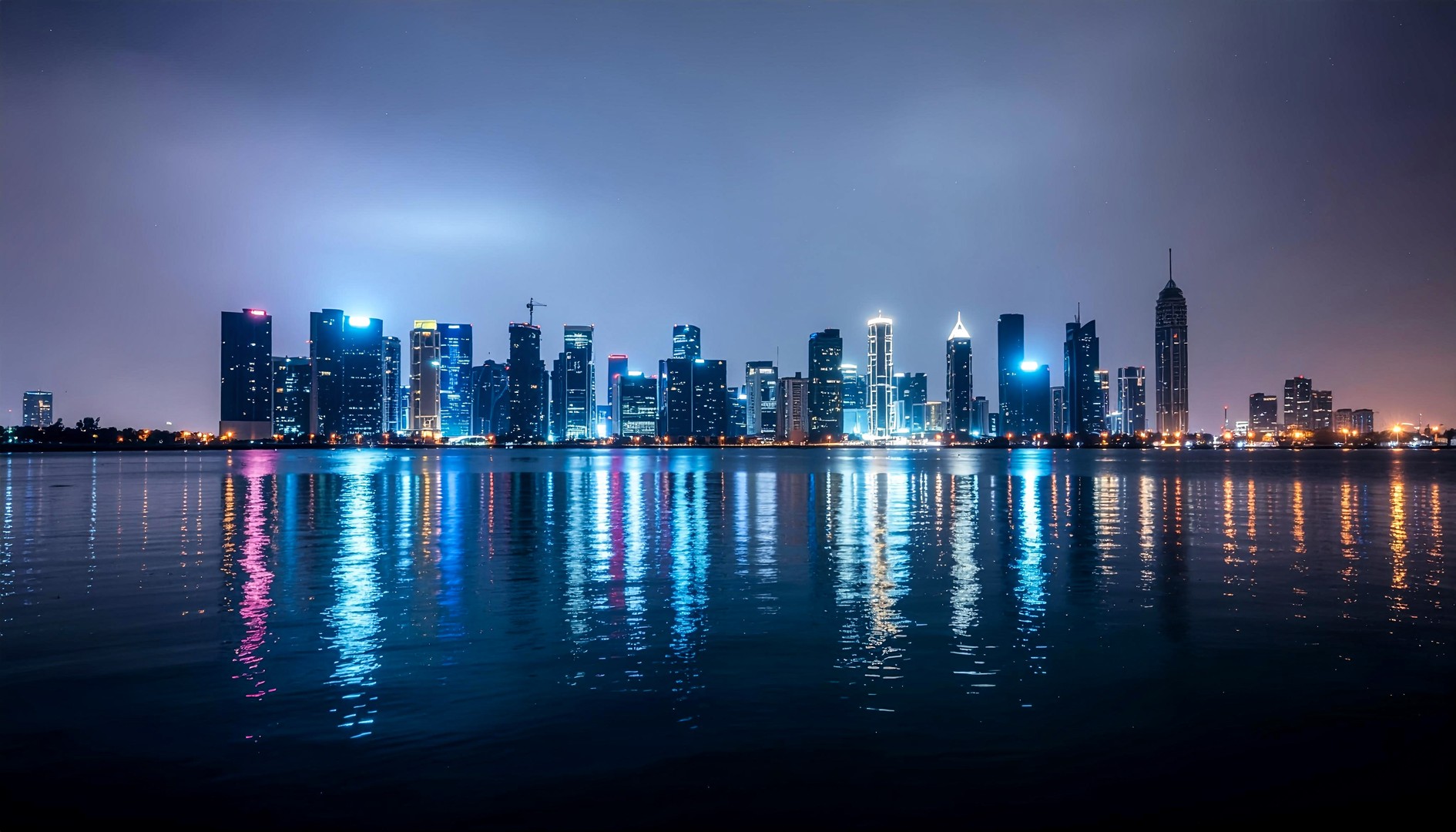 Modern City Skyline Reflection at Night Desktop Wallpaper