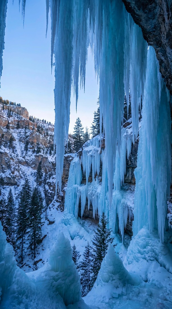 Blue Ice Cave with Hanging Icicles 4K Wallpaper