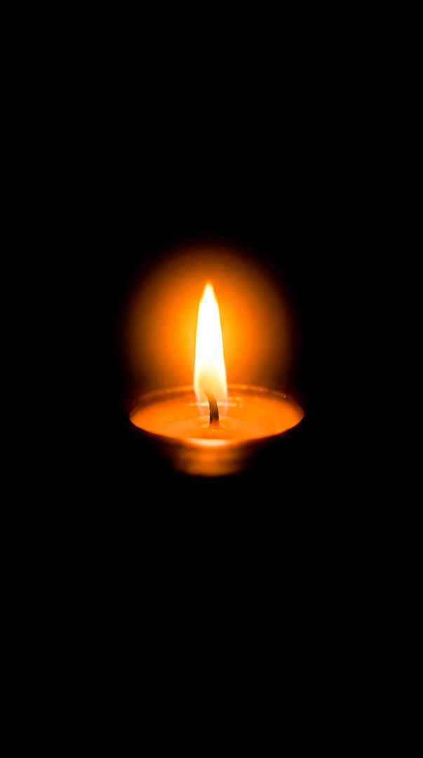 Single Candle Flame on Dark Background 4K Wallpaper